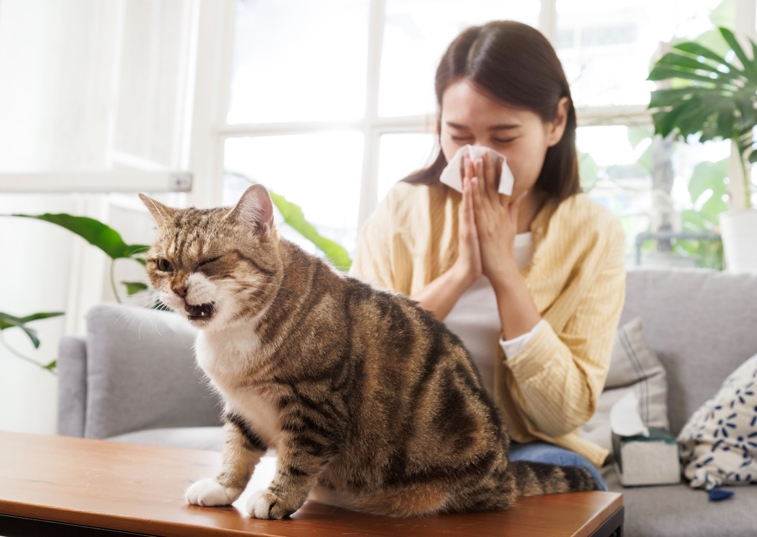 a woman and cat coughing