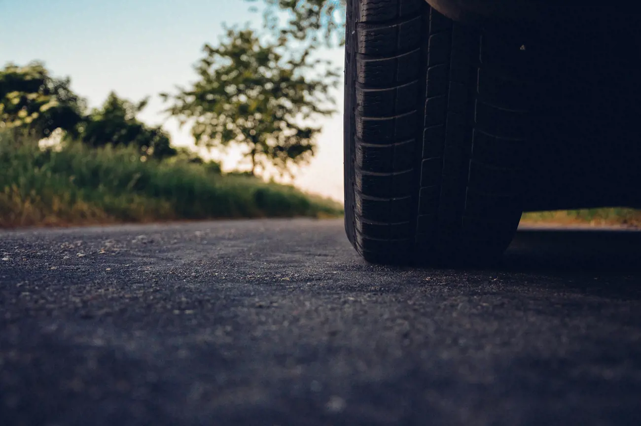 The wheel of a car stopped on the road