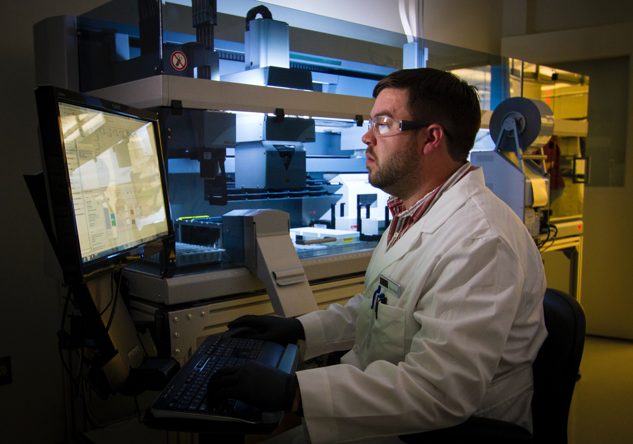 A scientist looking at a screen in a laboratory