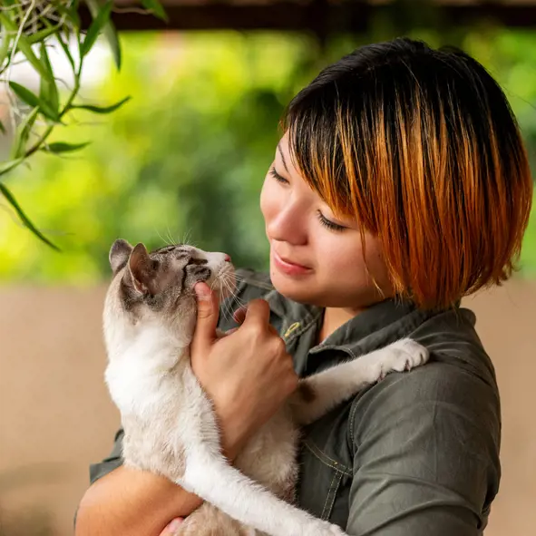 a woman holding a cat