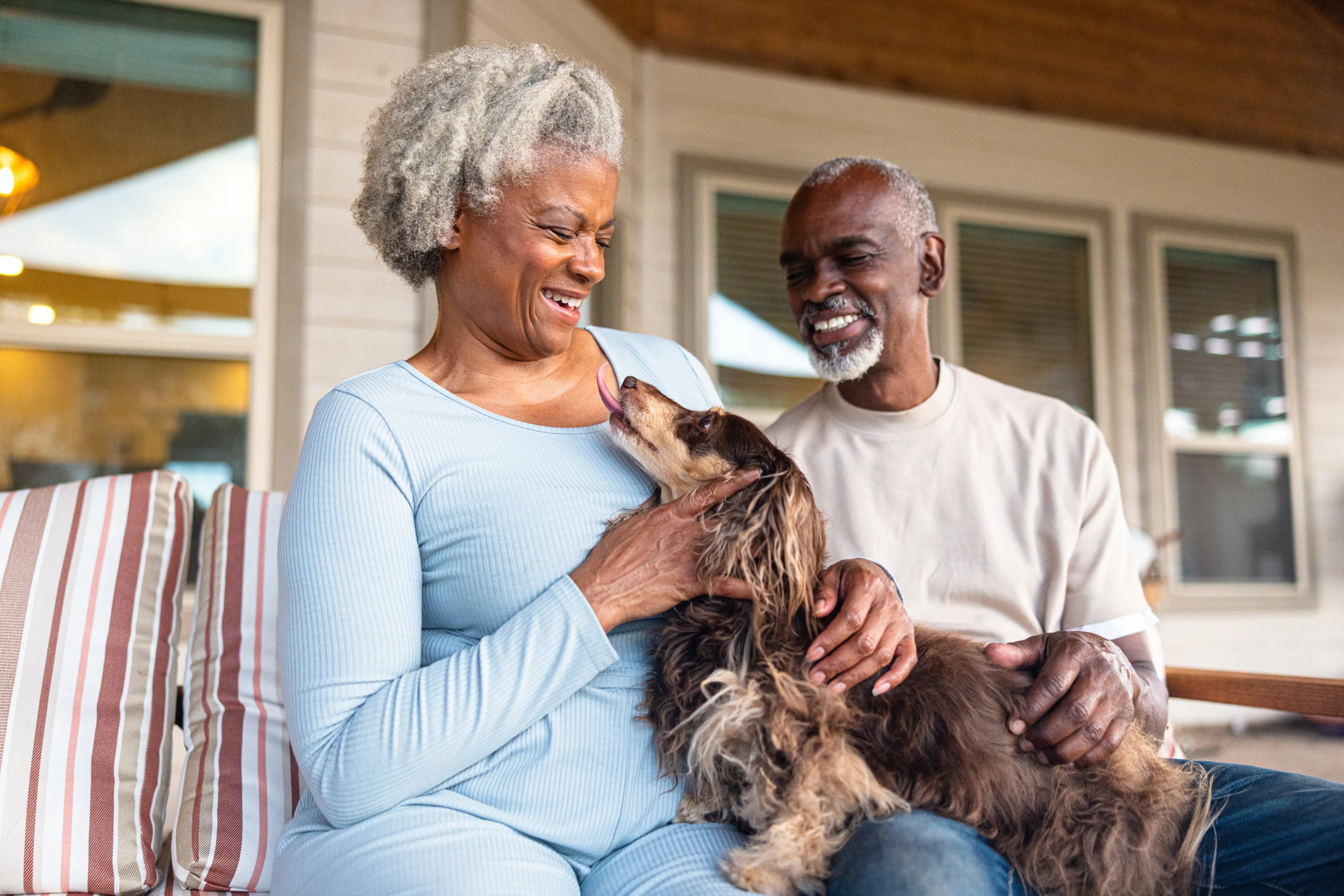 2 Elderly Black People Stroing A Brown Dog