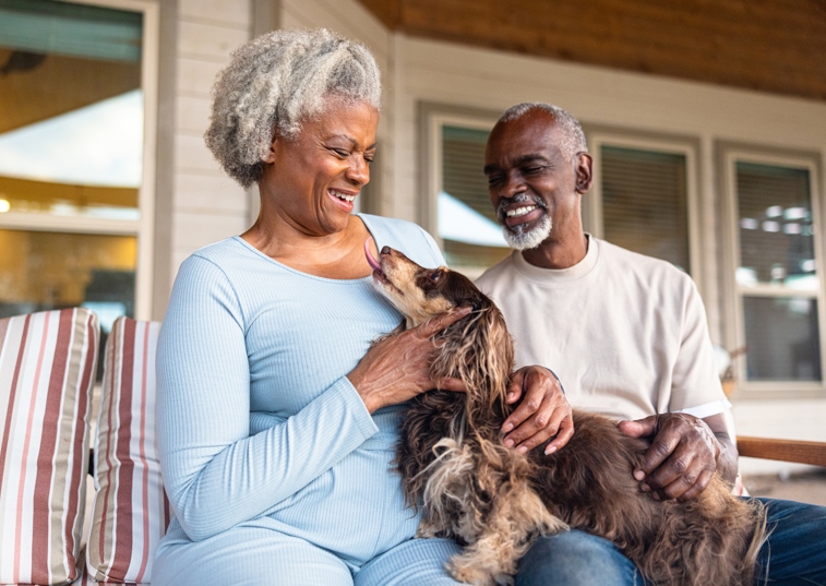2 Elderly Black People Stroing A Brown Dog