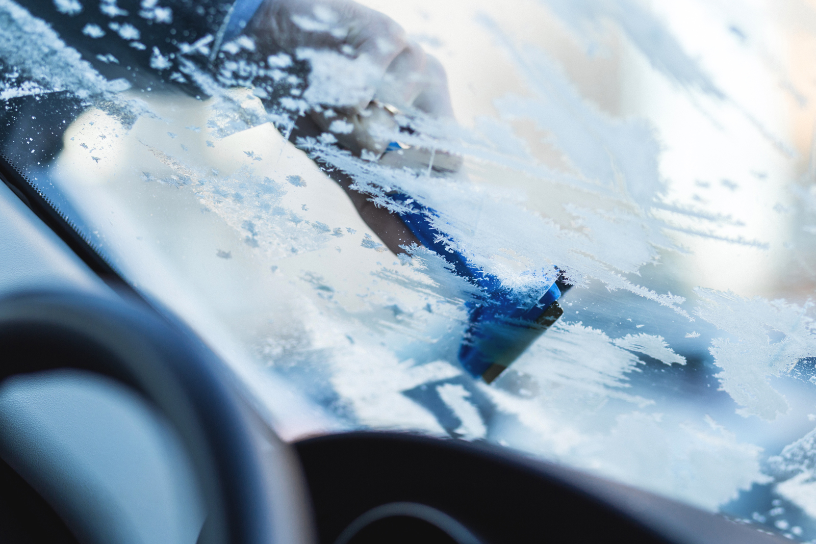 A view of a frozen over windscreen from inside the car