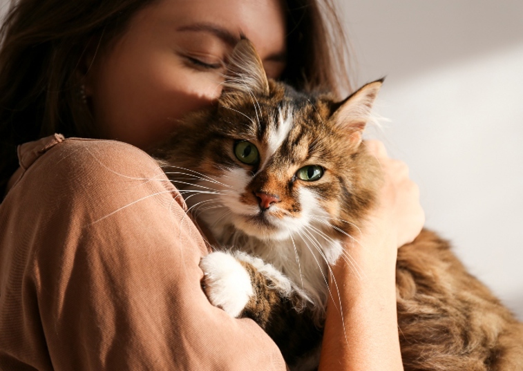 woman cuddling cat